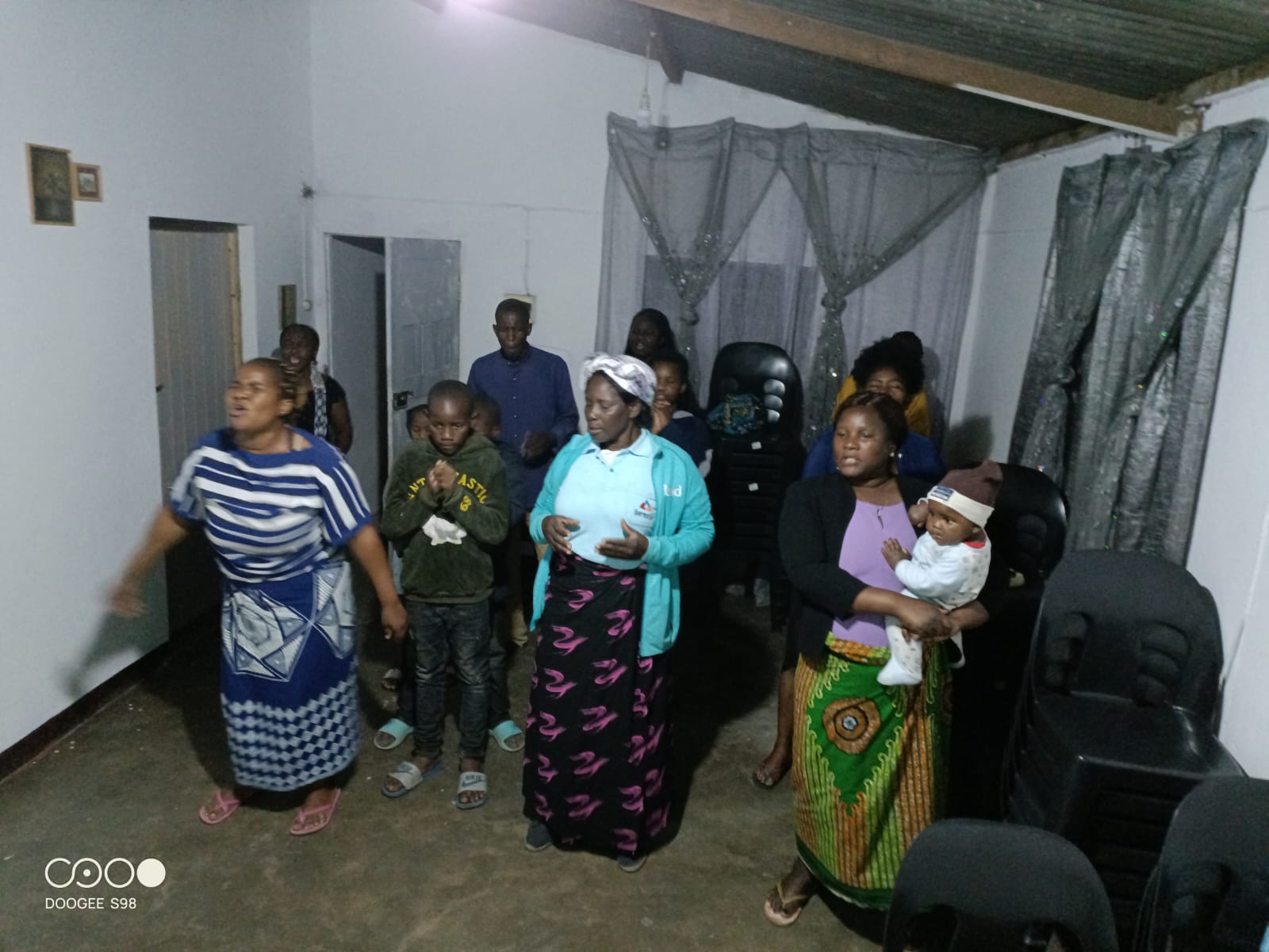 Orphanage and elderly care — a caregiver with children and elderly community members